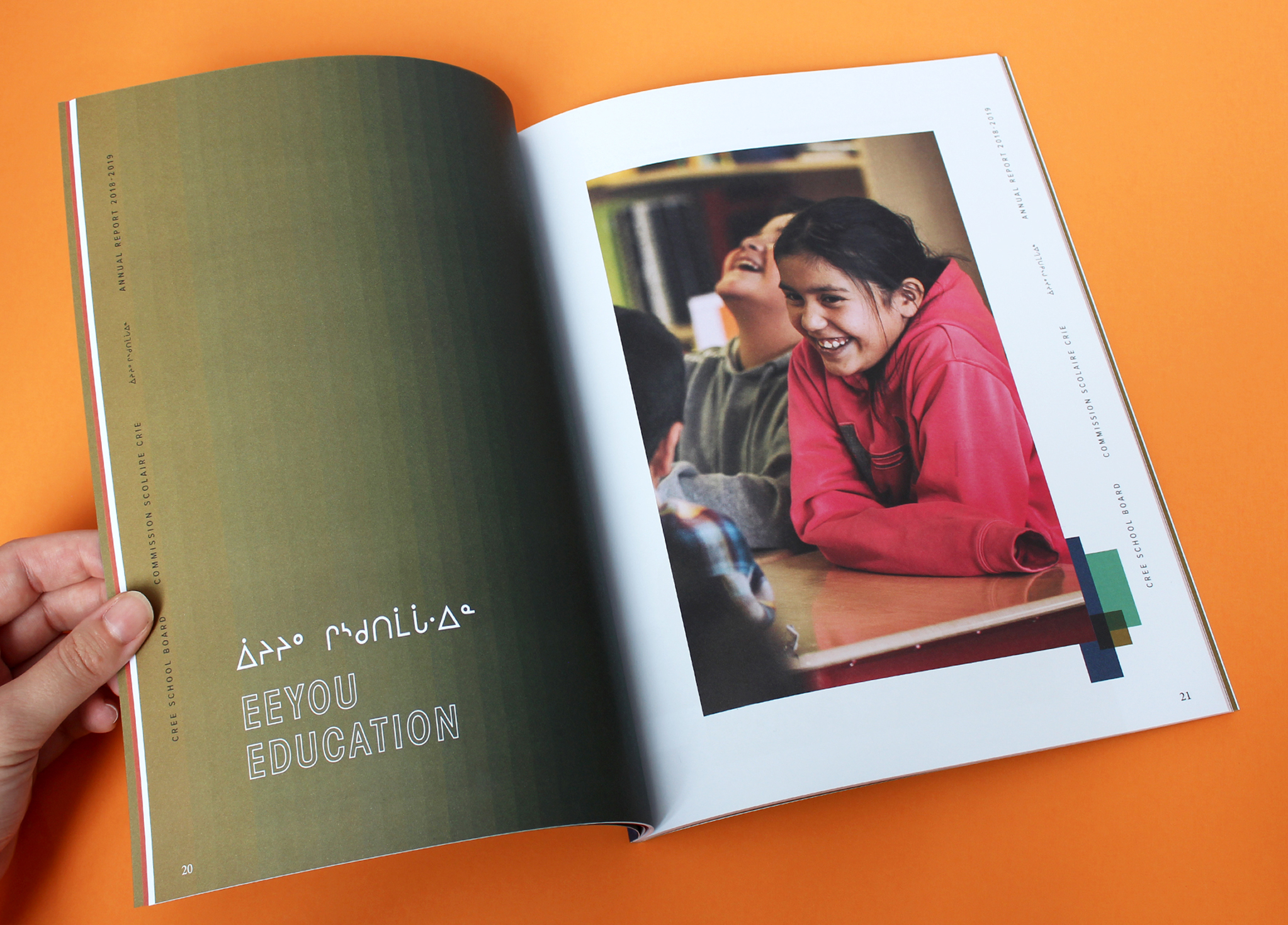 CSB_201819_Body-1 A person holds open a magazine showing a page titled