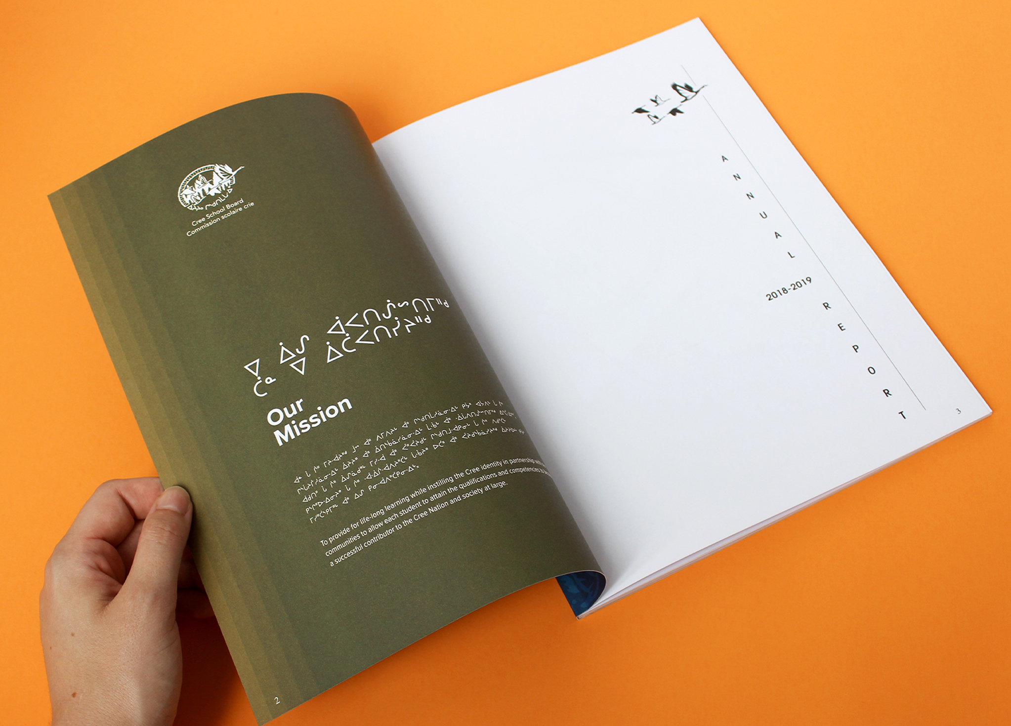 A hand opens a booklet with a green page titled