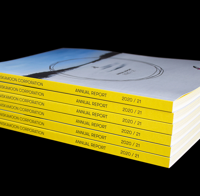 A stack of five yellow-covered annual reports from Nisga'a Lisims Government, titled