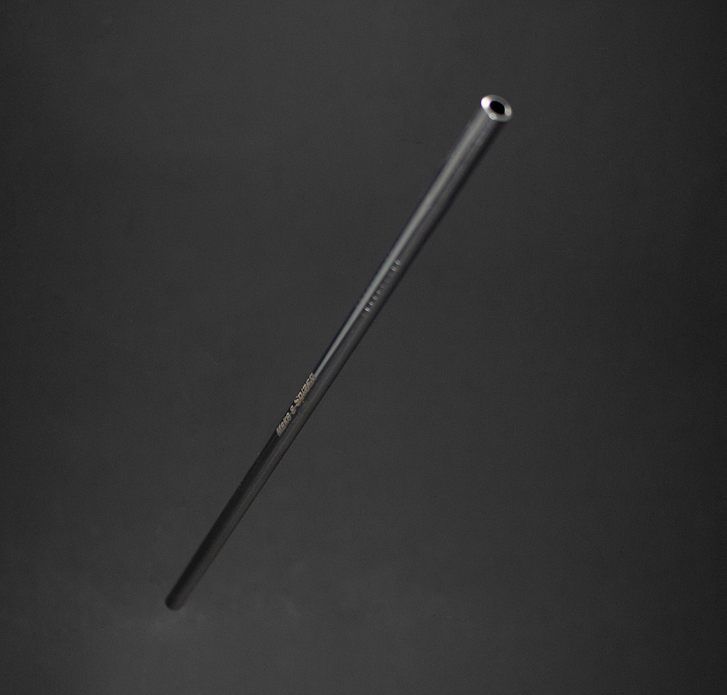 MakeaSplash_HolidayCard_2 A single black metal tube, possibly a pipe or rod, is suspended against a dark, gradient background. The tube appears hollow with a visible opening at one end.