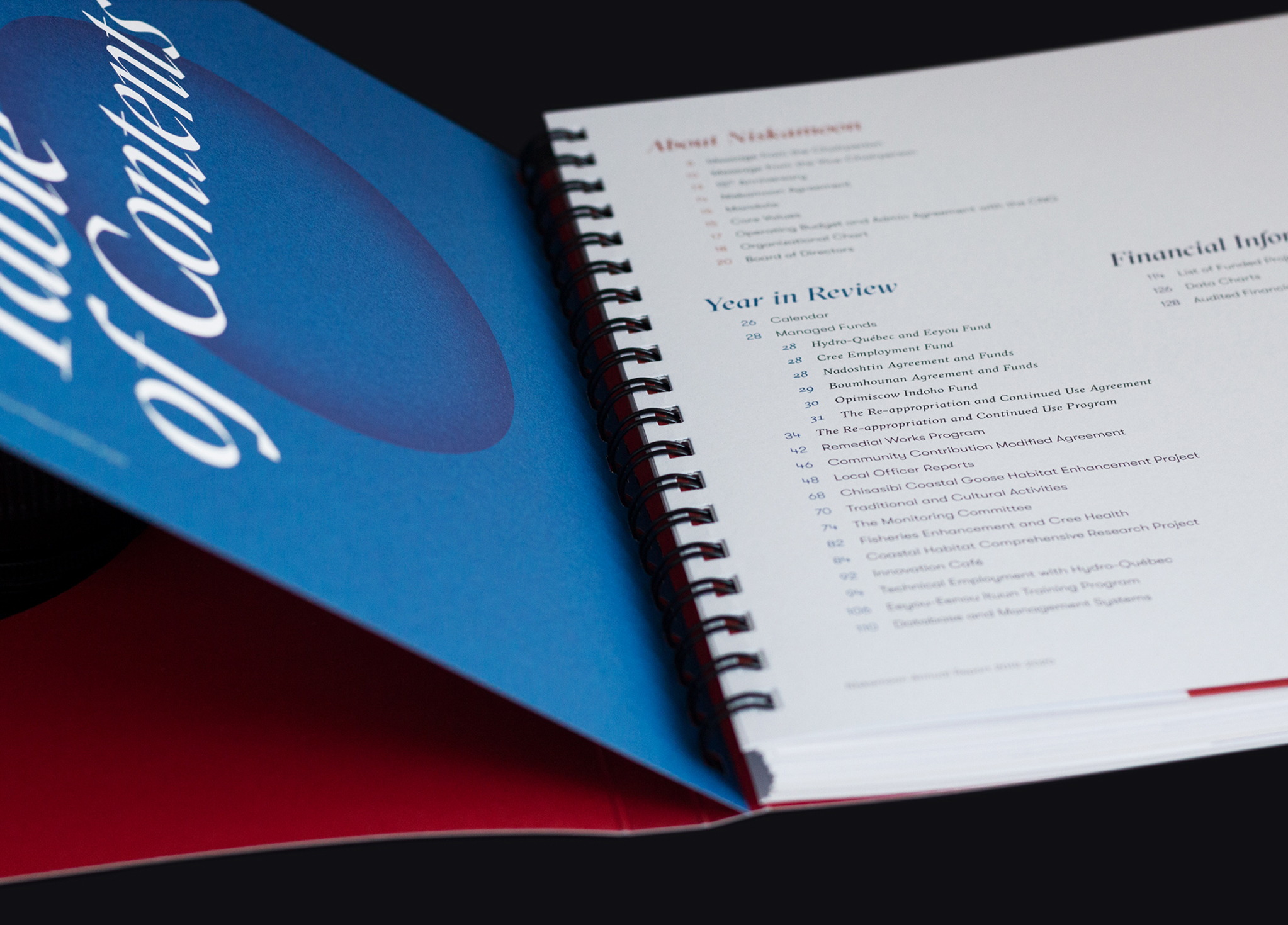 Niskamoon_201920-5 A close-up of an open spiral-bound book showing the table of contents on a white page, with a blue cover partially visible that reads