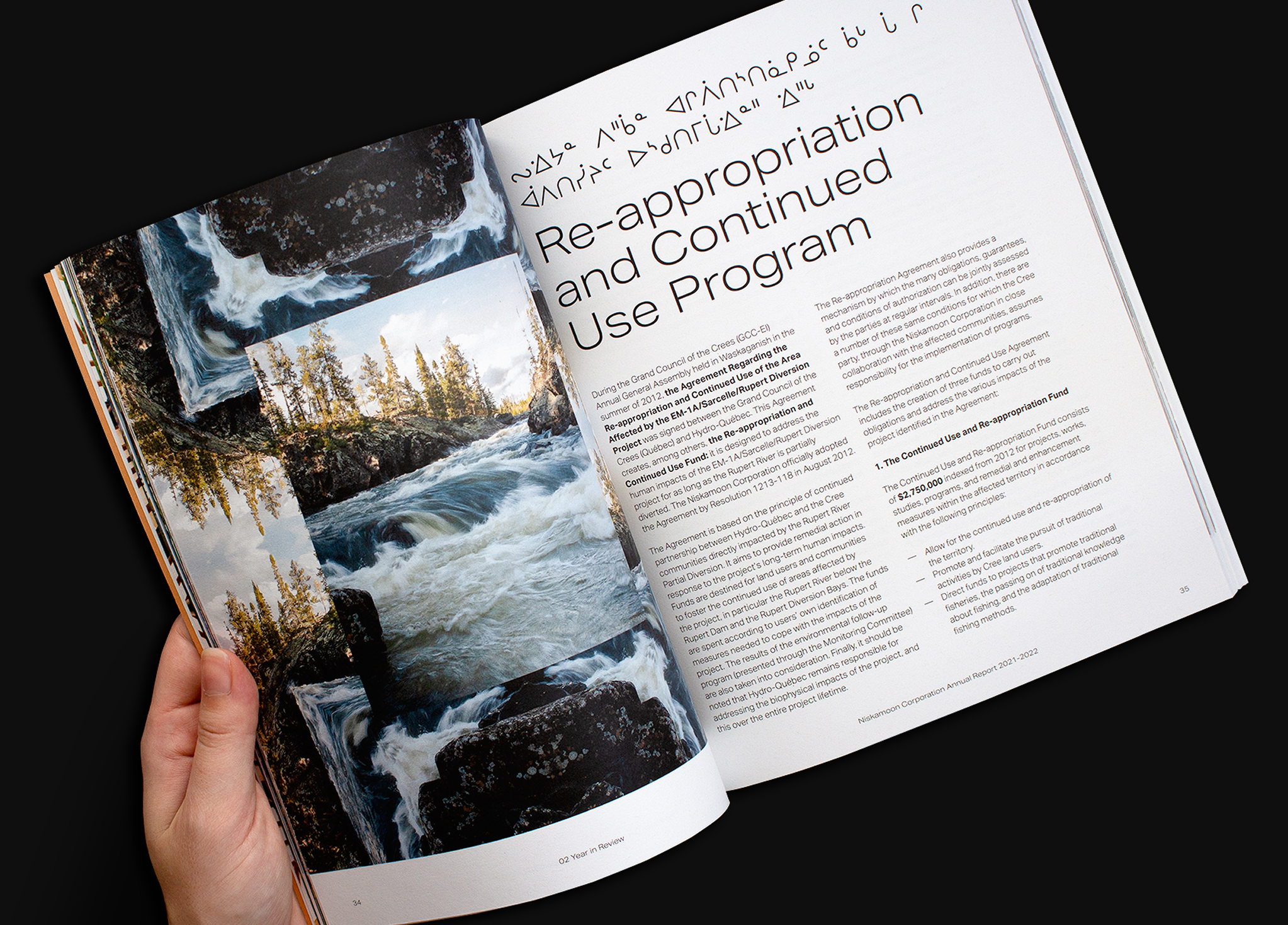 Niskamoon_202122-5 A hand holds open a magazine showing a spread. The left page features photos of a river and trees. The right page has an article titled