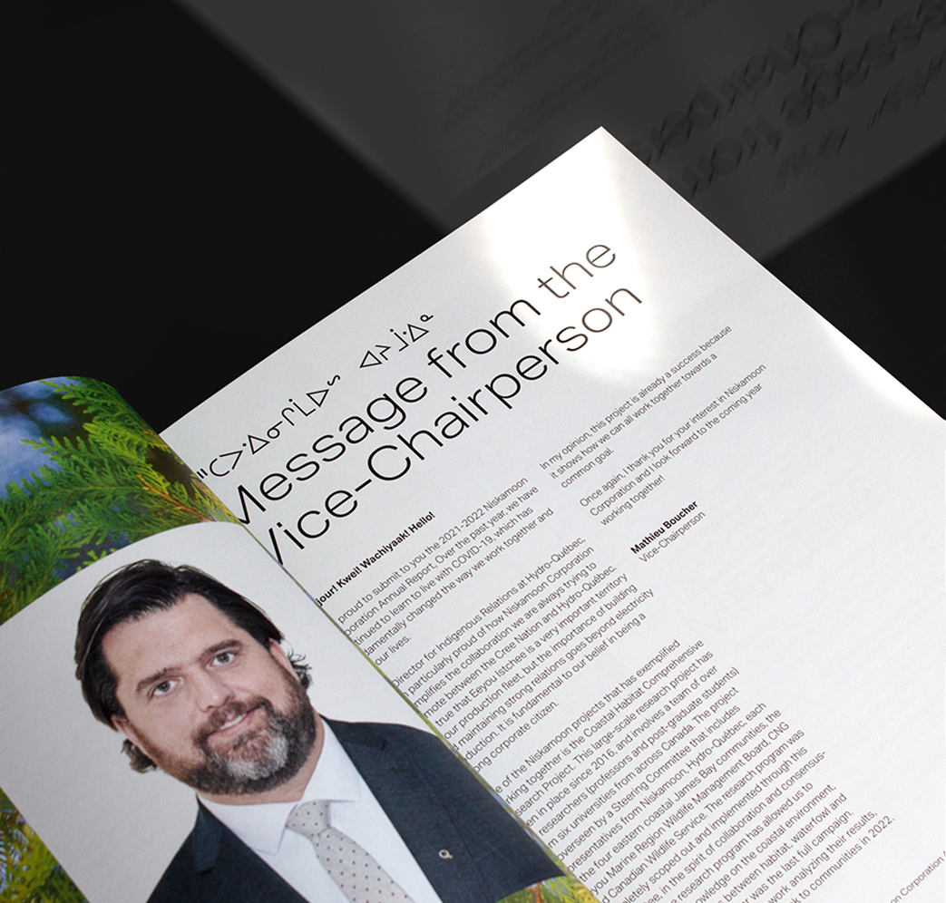 Niskamoon_202122-6 A magazine open to a page titled “Message from the Vice-Chairperson” featuring a portrait of a man in a suit and tie. The page includes text and a headline with both English and Inuktitut syllabics.