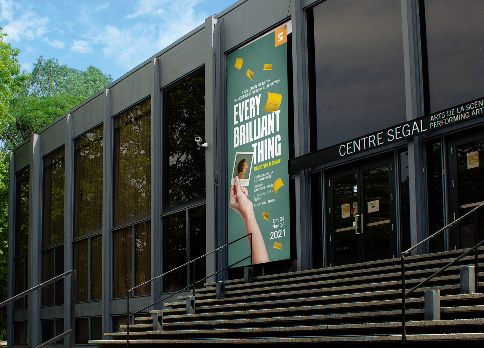 Segal_202122-4 A modern building with large glass windows and a sign reading