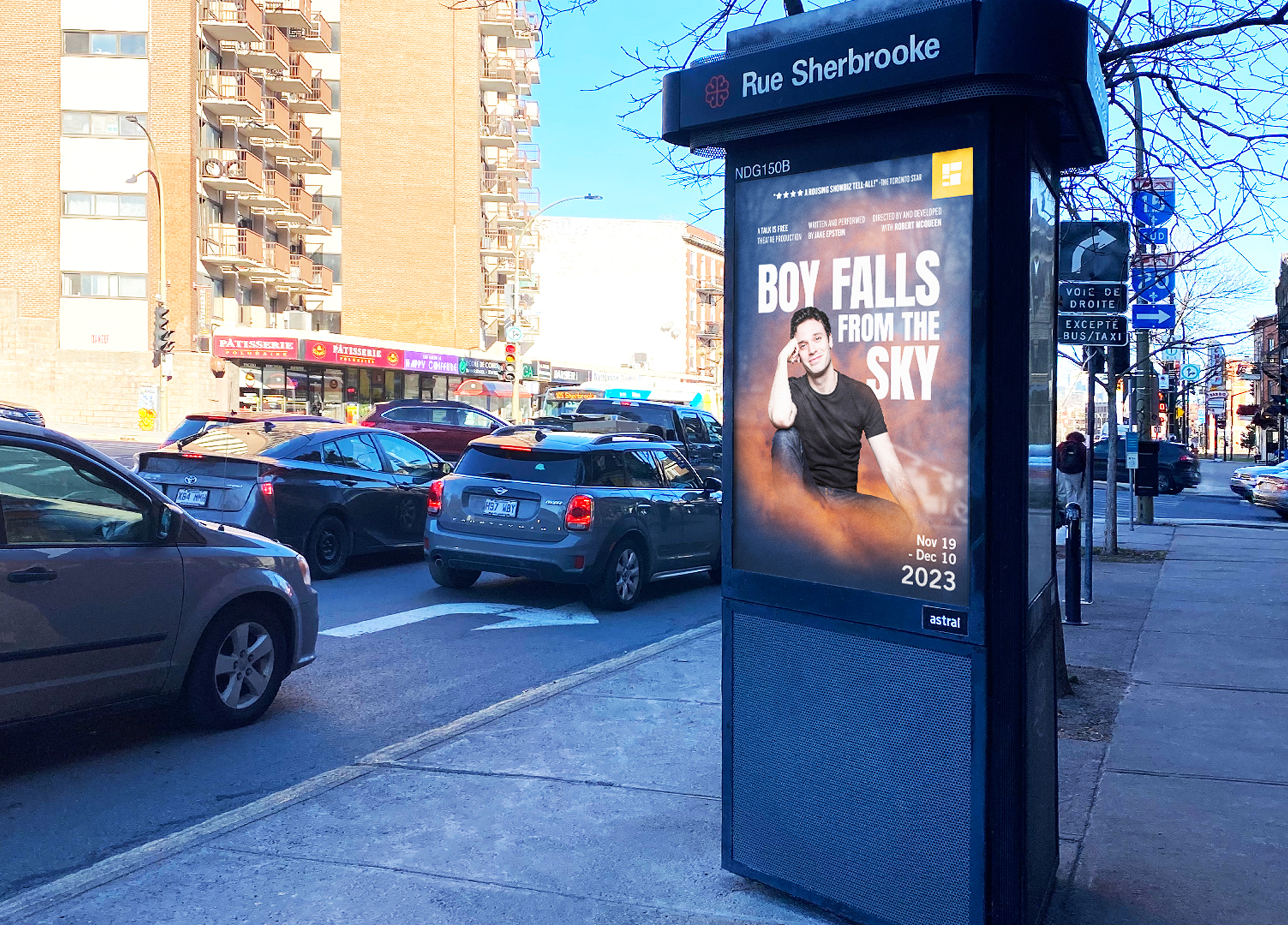 Segal_202324-6 A city street scene features a bus stop with a poster for the play