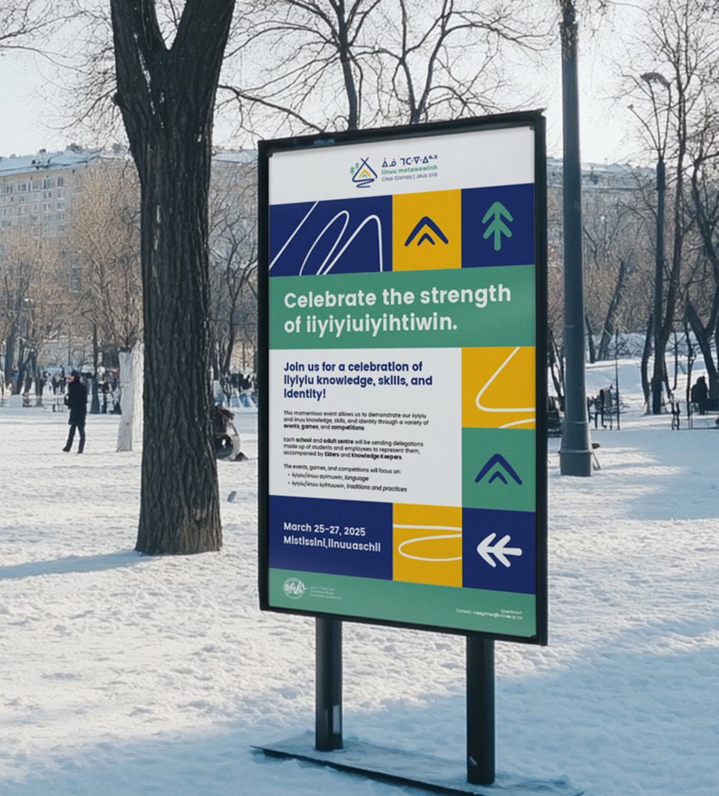 A sign in a snowy park displays a poster with colorful shapes and text inviting people to celebrate the strength of Iiiyiyuiyihtiw in March 2025; several people walk and trees are visible in the background.