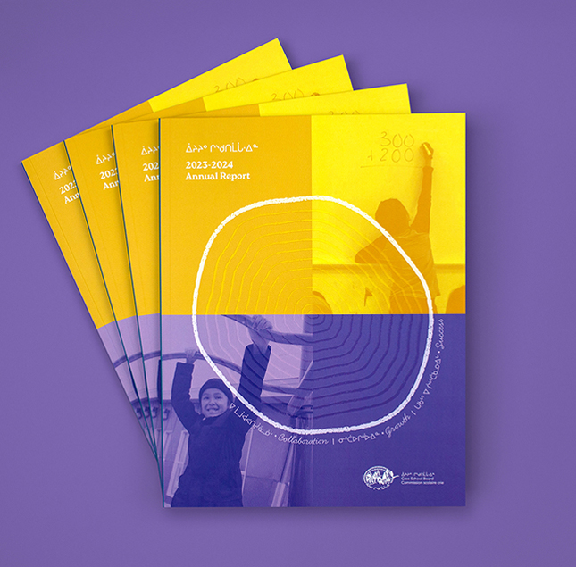 Four copies of a brightly colored annual report with yellow and purple sections, featuring abstract rings and a photo of a smiling person raising their hand. The cover reads