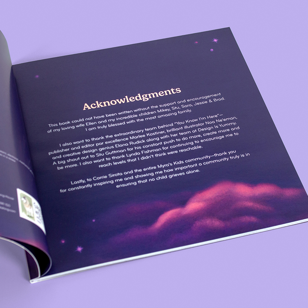 An open book on a purple surface displays the