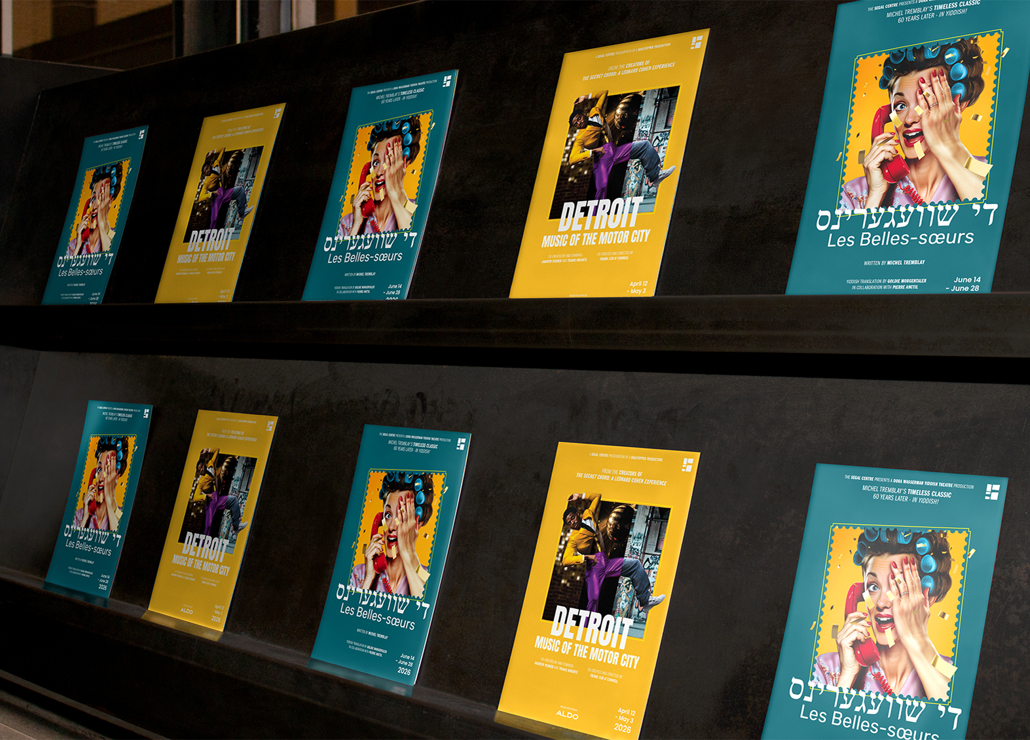 A display shelf holds alternating posters for two events: