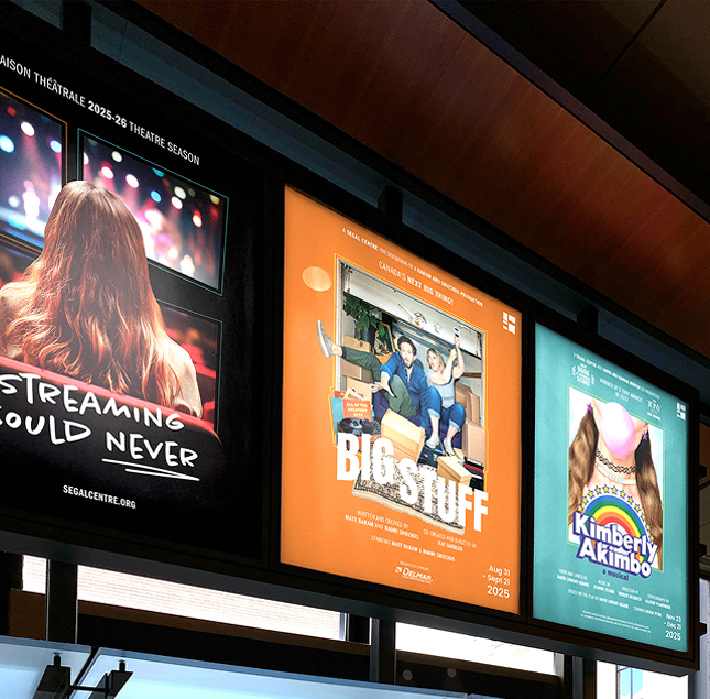 Three theater posters are displayed side by side: one shows a woman’s back with long red hair, one features two people in a cluttered room with “Big Stuff” text, and one has a colorful “Kimberly Akimbo” graphic.