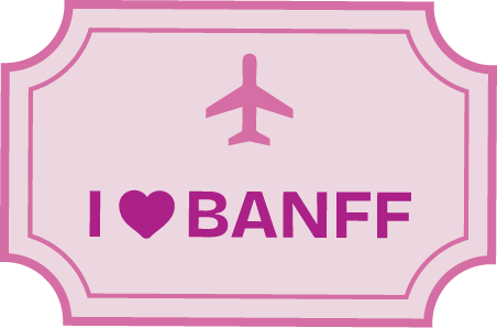 A pink sign with a dark pink airplane icon above the words "I ♥ BANFF" in bold letters, where the heart symbolizes "love." The sign has a decorative pink border.